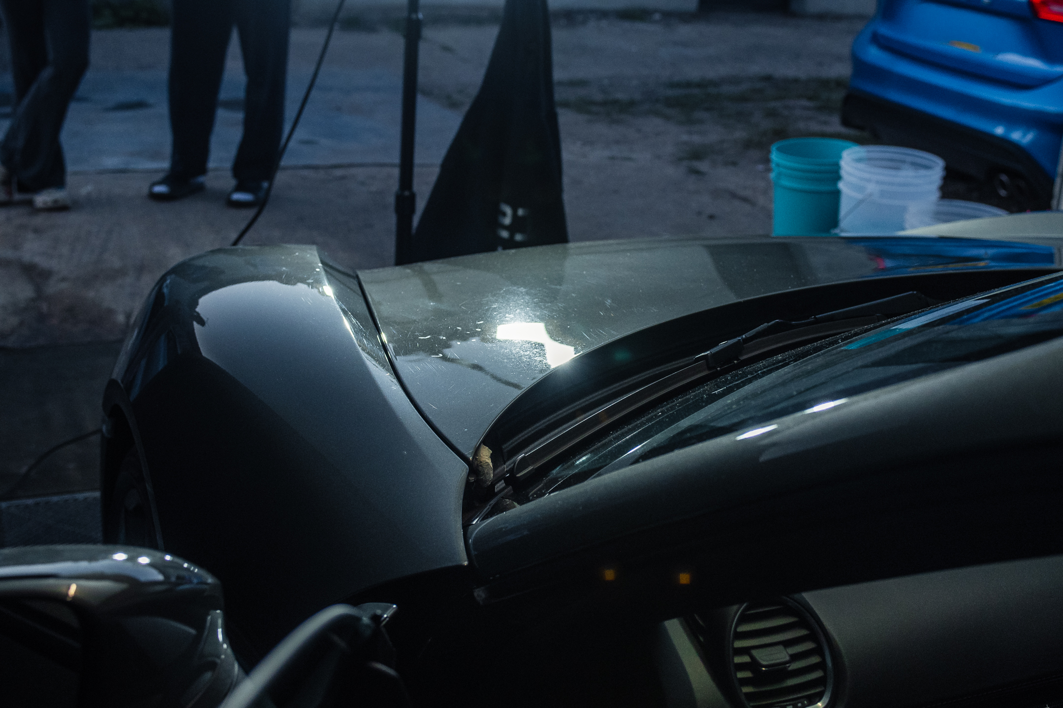 Paint inspection around a Porsche bonnet and windscreen